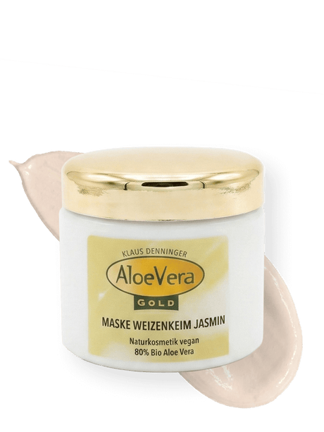 Tiegel der Aloe Vera Gold Creme Maske Weizenkeim Jasmin zur Gesichtsreinigung mit einem Cremestrich im Hintergrund